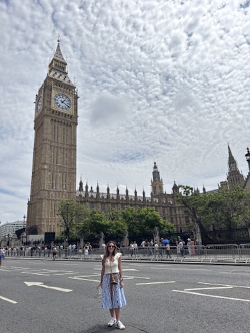 Danielle standing calmly beneath the clock tower at Big Ben, reflecting on strength, authority, and safety through a personal lens.