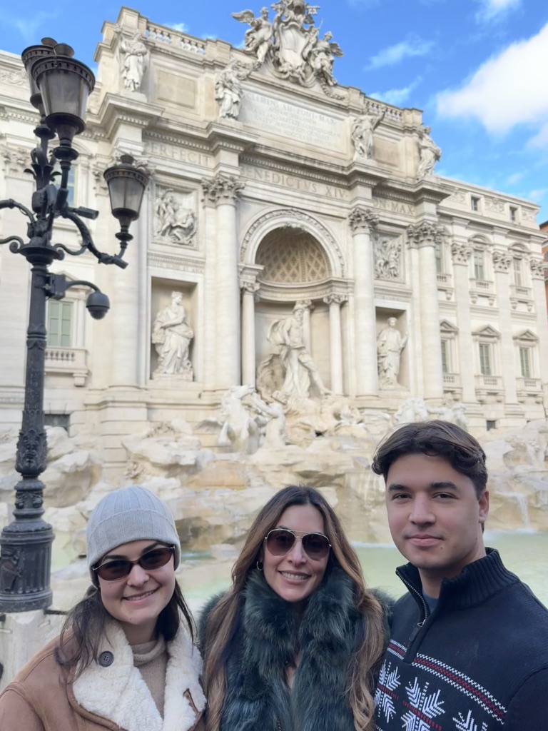 Danielle standing with her young adult son and daughter at the Trevi Fountain in Rome, reflecting on motherhood, faith, and building what lasts.
