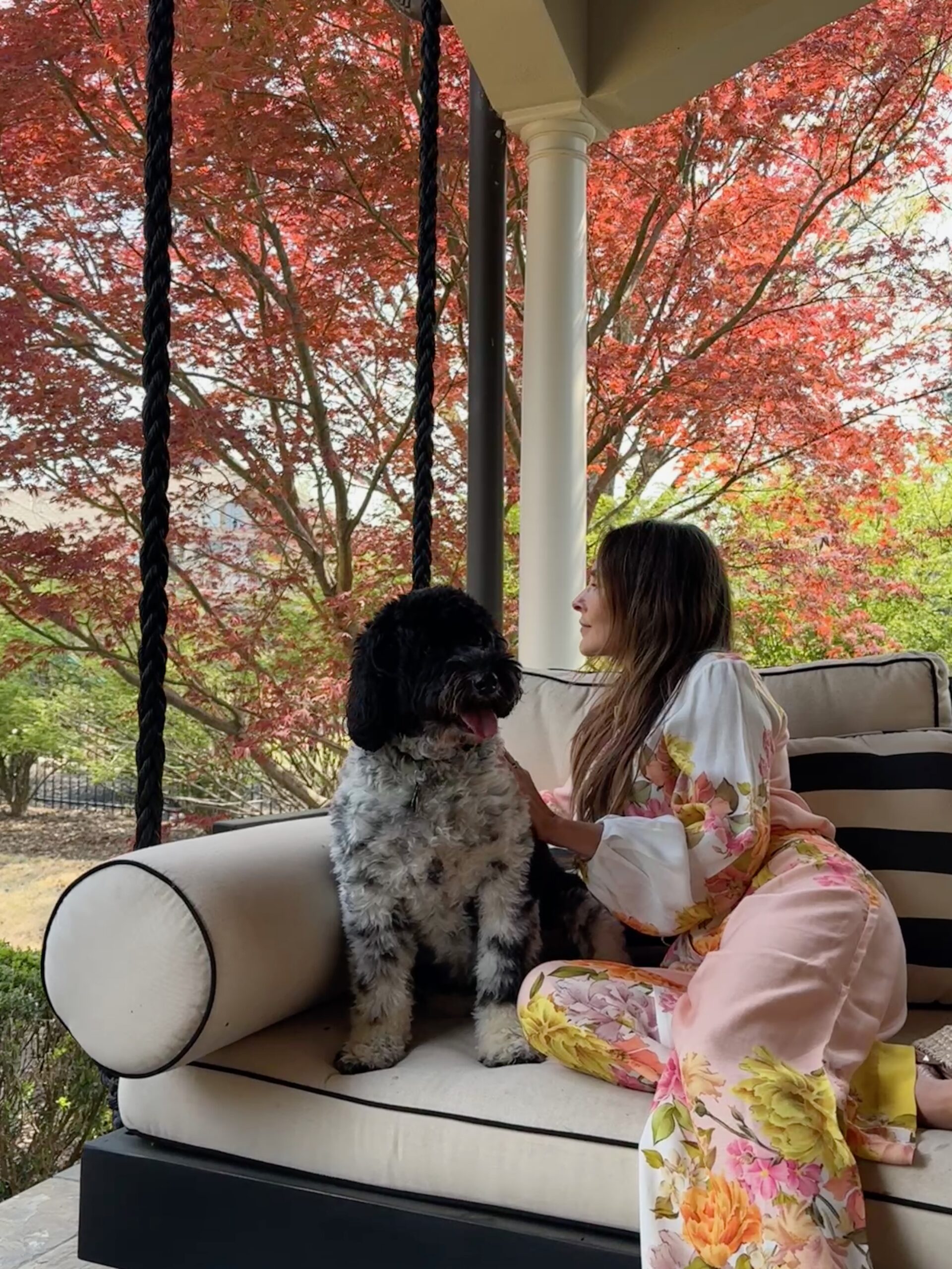 Danielle Alvarez Greer sitting on a porch swing with her dog, resting after a migraine and reflecting on trusting God through chronic pain
