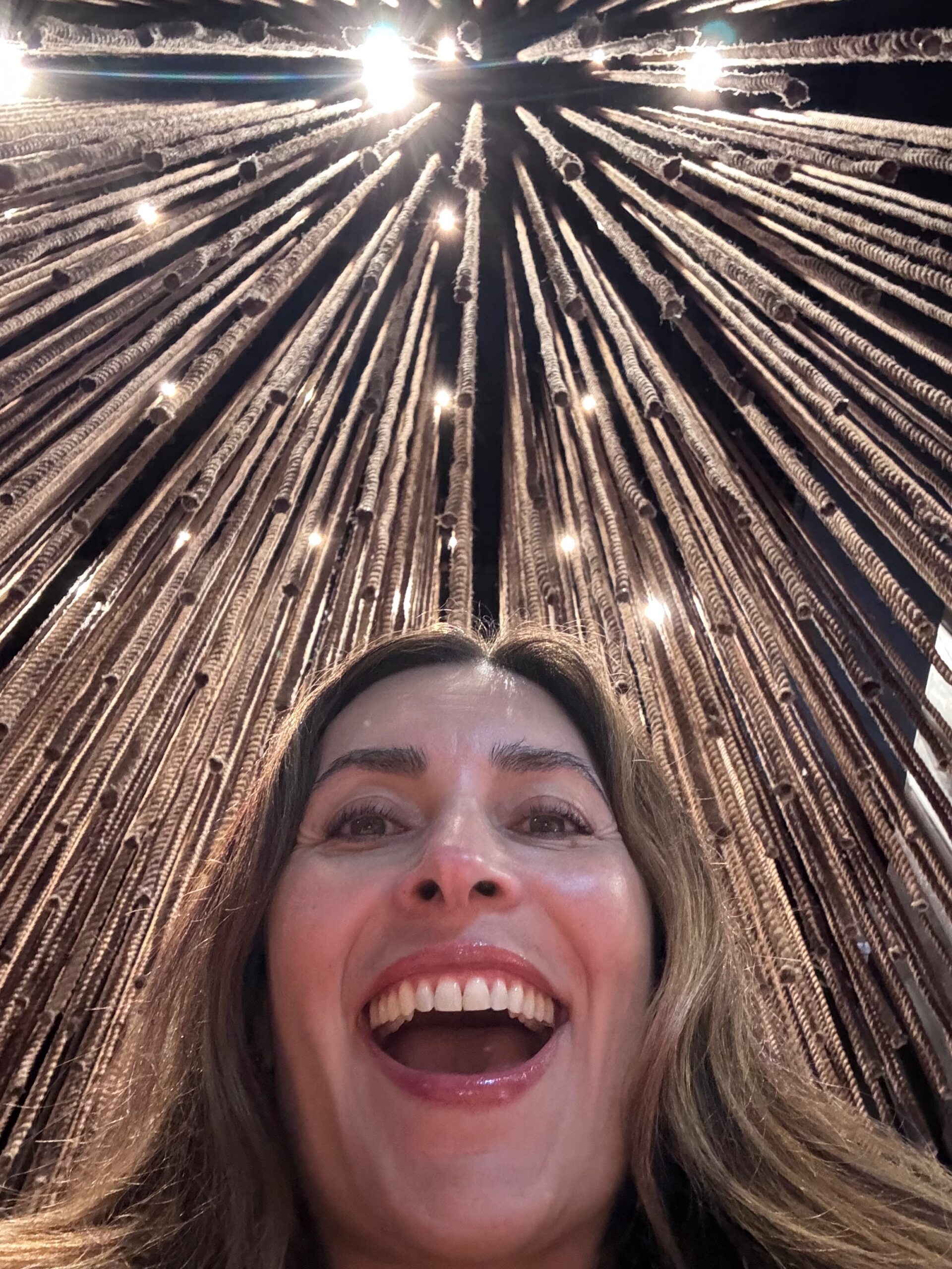 A woman smiling with joy and peace, representing letting go of control and trusting God for security and rest