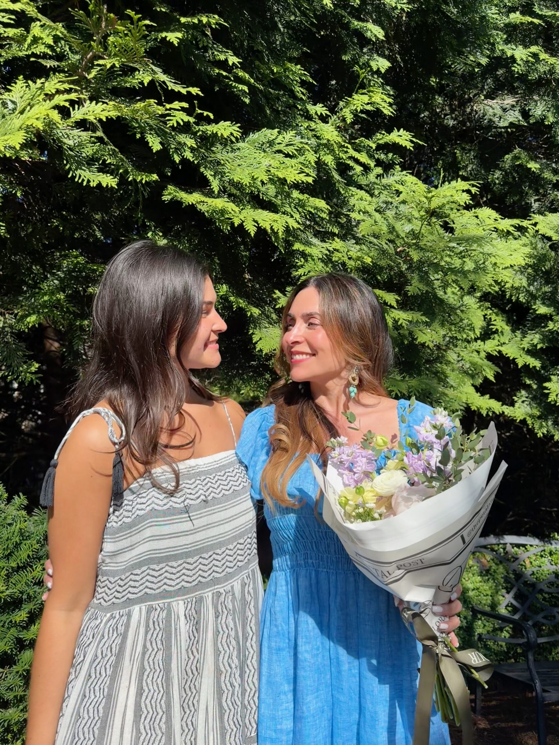 Mother and teenage daughter smiling at each other outdoors on Mother’s Day, representing healing, connection, and generational restoration through faith