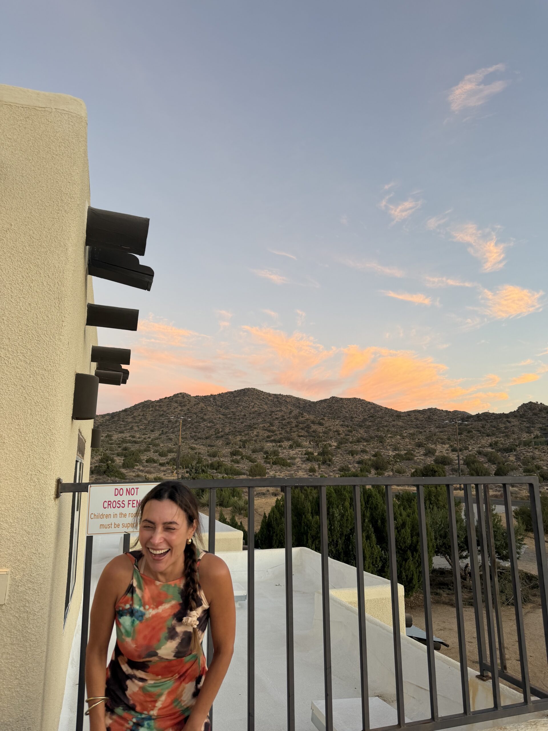 Danielle Alvarez Greer smiling at sunset during the Renew & Restore Women's Retreat in Joshua Tree, California, reflecting on healing, trust, and freedom in Christ.