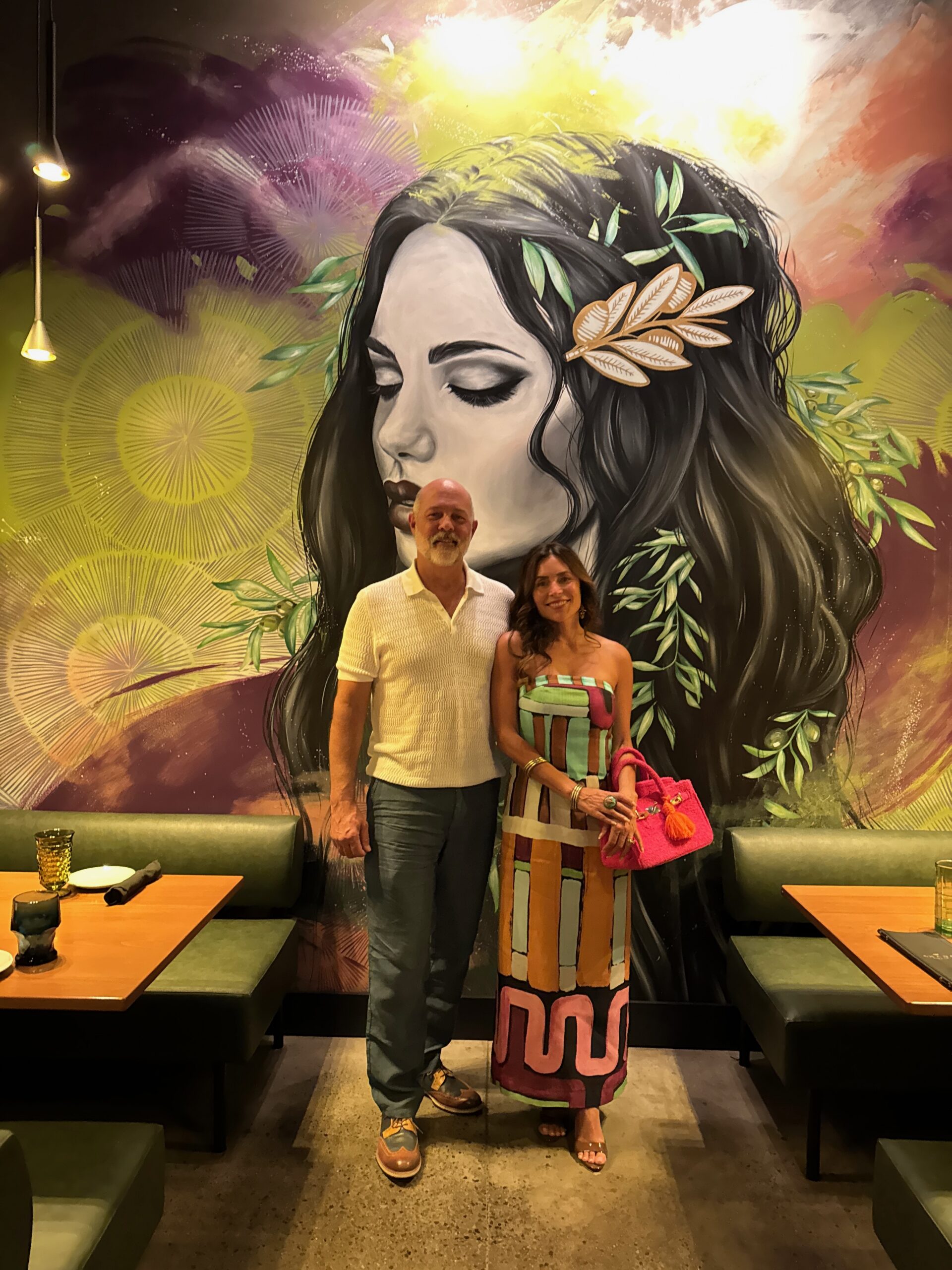 Danielle Alvarez Greer and her husband Jack smiling together during an impromptu Chattanooga date night at Amada Tapas before dancing at a First Wave 80s Night show.