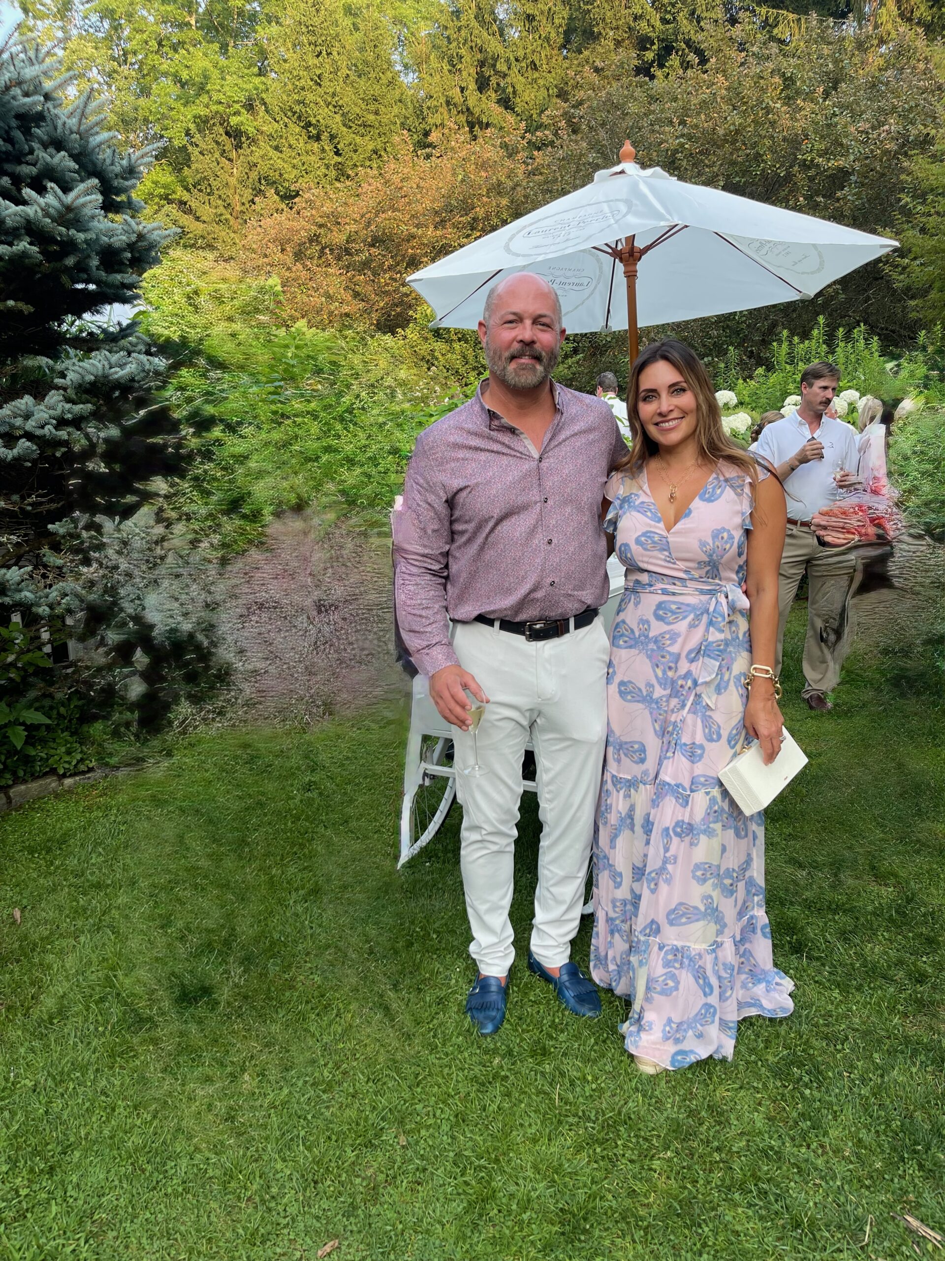 Danielle standing outdoors at an event in a pink and blue butterfly dress, the dress referenced in her Episode 127 story about shame, discernment, and spiritual pressure.